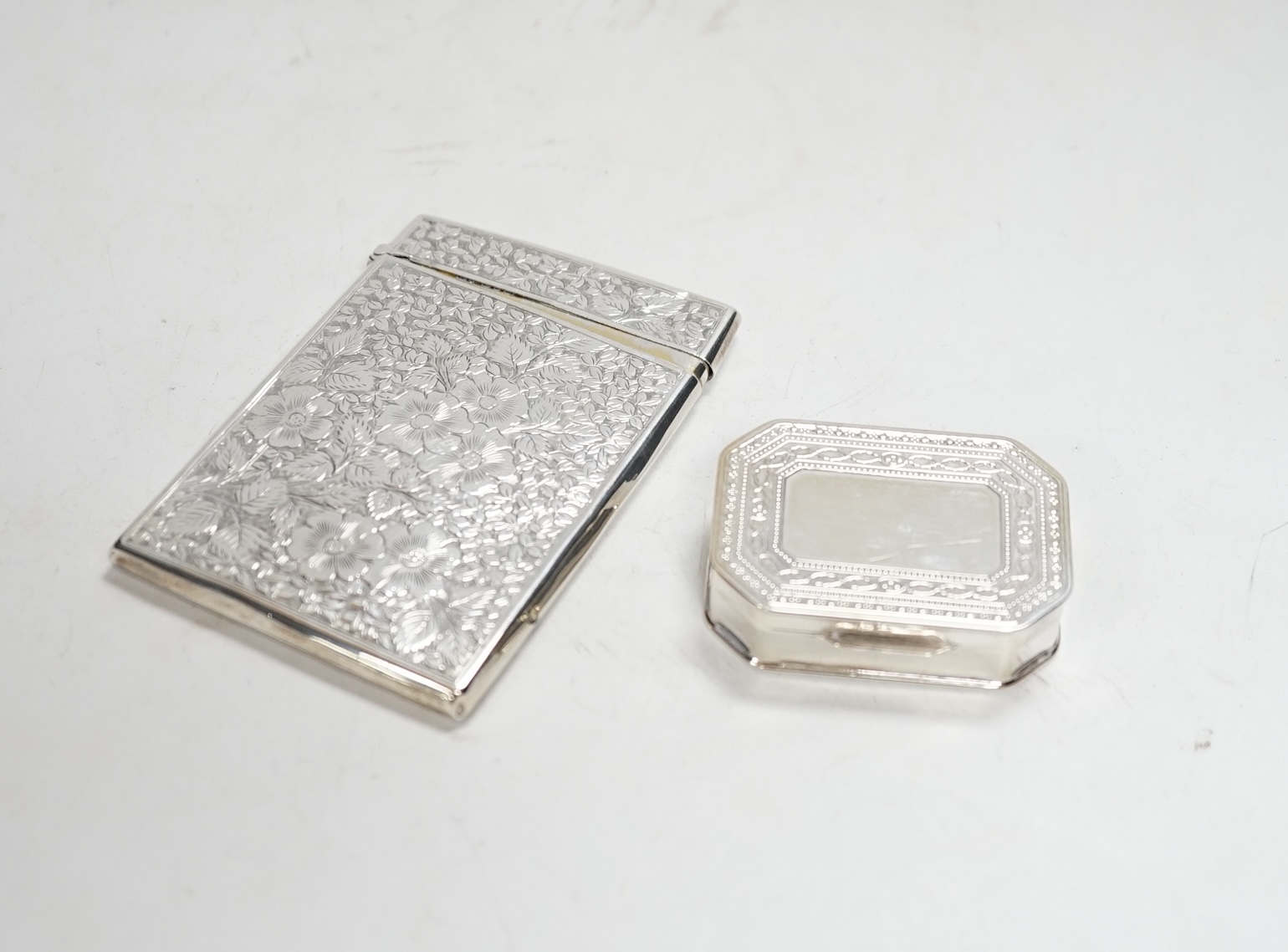 A late Victorian engraved silver rectangular card case, George Unite, Birmingham, 1895, 99mm, together with a modern silver pill box.